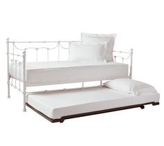 a white daybed with a pull out trundle bed frame and mattress on it