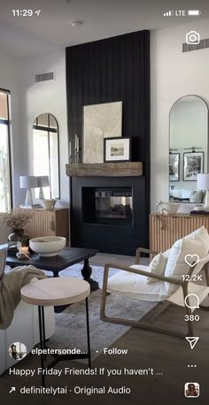 a living room filled with furniture and a fire place in front of a mirror on the wall