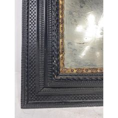 an ornate framed mirror hanging on the wall