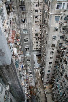 an aerial view of some very tall buildings in a big city with lots of windows and balconies