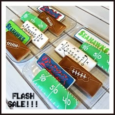 some football themed cookies are in a plastic container on a table with the words flash sale written on them