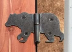 an iron door hinge is shown on the side of a wooden door