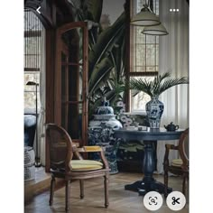 an image of a living room setting with vases on the table and two chairs