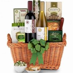 a basket filled with lots of different types of food and wine bottles next to each other