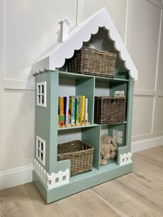 a toy house with books and toys in it