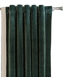 green velvet curtains hanging on a curtain rod