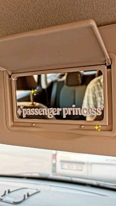 the passenger princess sticker is hanging on the back of a car