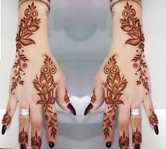 two hands with henna designs on them