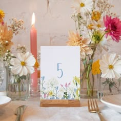 a table set with flowers and candles for a 5 year wedding anniversary party or special occasion