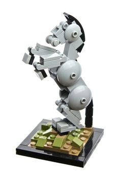 a lego robot standing on top of a pile of blocks