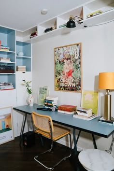 a room with a desk, chair and bookshelf on the wall next to it