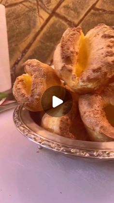 a silver plate filled with pastries on top of a table