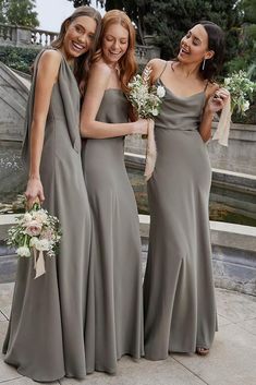 three bridesmaids in long gray dresses standing next to each other