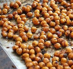 roasted chickpeas on a baking sheet ready to be cooked