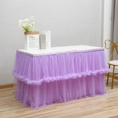 a table with a purple tulle skirt on it