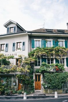 an old building covered in vines and flowers