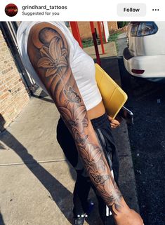 a man with a tattoo on his arm and leg is standing in front of a white car