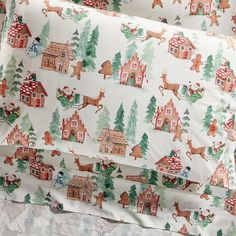 the bedding is covered with christmas themed sheets