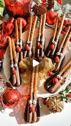 a plate topped with chocolate covered pretzels next to candy canes and christmas decorations