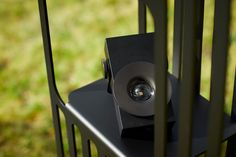 a speaker sitting on top of a black stand