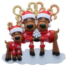 three reindeer figurines wearing red and white outfits