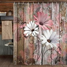 a shower curtain with pink and white flowers on the wooden planks in a rustic bathroom