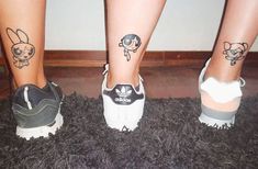 three people with matching tattoos on their legs