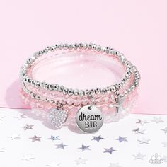 Reflective pink, defaced silver, reflective white, and smooth silver beads wrap around stretchy bands, and combine into a colorful stack along the wrist. The reflective, pink-beaded bracelet features a silver pendant with the phrase "dream BIG" stamped on it, while a defaced, silver-beaded bracelet features a silver star charm. Hanging from smooth, silver beads, a heart charm embossed with iridescent rhinestones adds a shimmery detail to the stack, resulting in a youthful, dreamy design. Due to Pink Beaded Bracelets, Pink Charm, Blue Beaded Bracelets, Snap Bracelets, Inspirational Bracelets, Wooden Bracelet, Beaded Wraps, Paparazzi Accessories, Seed Bead Necklace