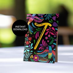 a colorful card with the letter t on it