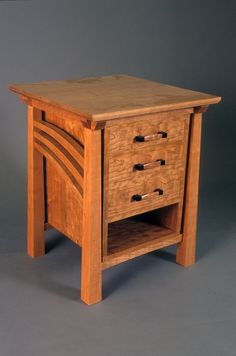 a small wooden table with two drawers