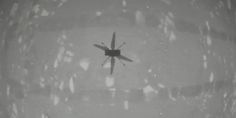 an airplane is flying through the air on a foggy day in black and white