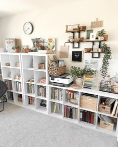 a white book shelf filled with lots of books and other items on top of it