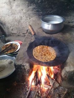 an open fire with food cooking over it