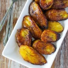 some fried bananas on a white plate with a fork