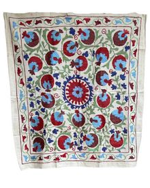 an embroidered cloth with red, blue and green designs