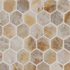 a close up view of a marble mosaic tile wall with hexagonal tiles on it