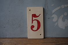 the number five is painted red and white