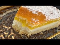 a piece of cake sitting on top of a gold plate next to a knife and fork