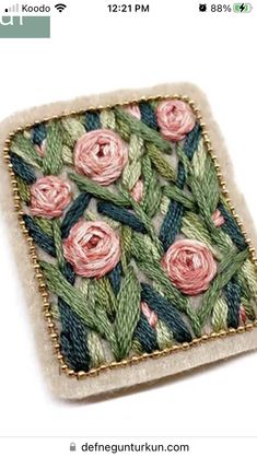 a close up of a square shaped object with flowers on the front and back of it