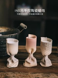 three different types of candle holders on a table