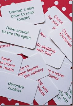 some white tags with red and green words on them sitting on a polka dot tablecloth