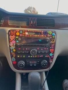 the dashboard of a car decorated with hearts and peace signs on it's dash board