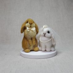 two small stuffed animals sitting next to each other