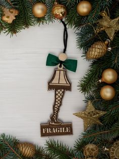 a christmas ornament hanging from the side of a tree with ornaments around it