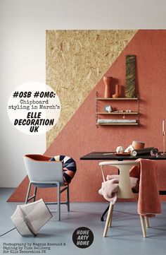 a room with orange and pink walls, furniture and decor on the floor in front of a wooden shelf