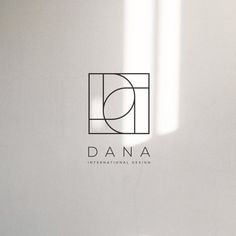 the logo for dana international design is shown in black and white, as well as an orange vase