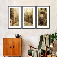 three framed pictures hang on the wall next to a chair and sideboard in a living room