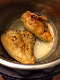 two pieces of chicken sitting in a pot