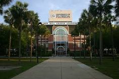 the university of florida building is surrounded by palm trees