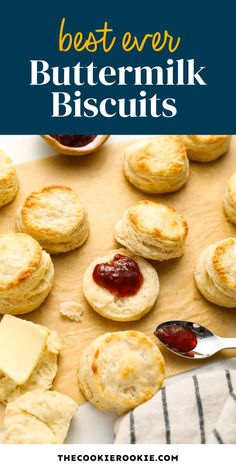 buttermilk biscuits on a baking sheet with jam and butter in the background text overlay reads best ever buttermilk biscuits